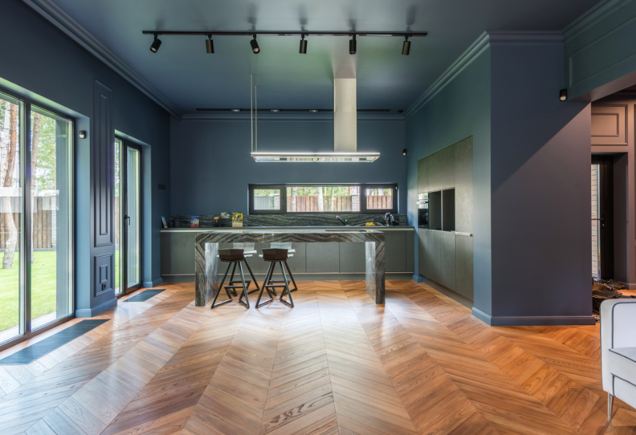 modern dark dining room with warm herringbone flooring